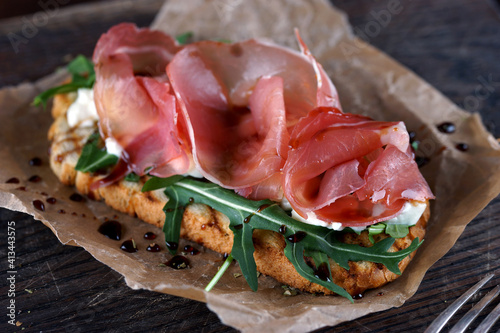 Bruschetta with parma on a wooden board for serving