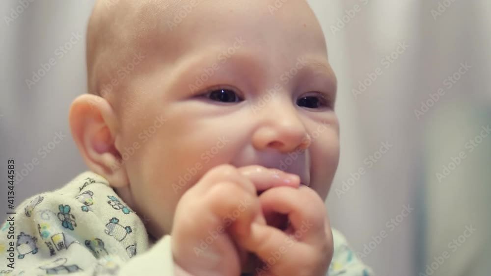 A cute little baby is looking into the camera. A cute little baby is looking into the camera.