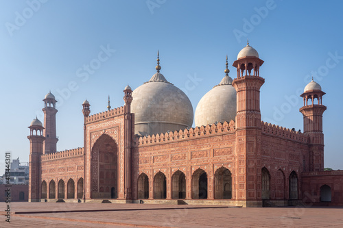 Side view of beautiful ancient Badshahi mosque with courtyard built by mughal emperor Aurangzeb a landmark of Lahore, Punjab, Pakistan photo