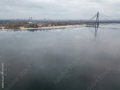 Wallpaper Mural Reflection of the sky in thin ice on the Dnieper River in Kiev. Aerial drone view. Winter cloudy morning. Torontodigital.ca