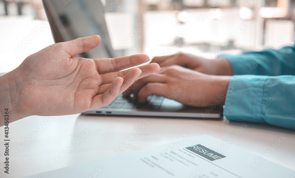 Fototapeta premium Employer or HR leader is interviewing participants, applying for a company employee, and having read the proficiency test resume to recruit qualified employees, Selection of job applicants.