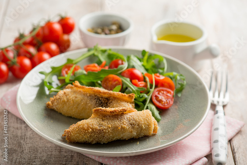 rolled sword fish with capers arugula and tomatoes salad
