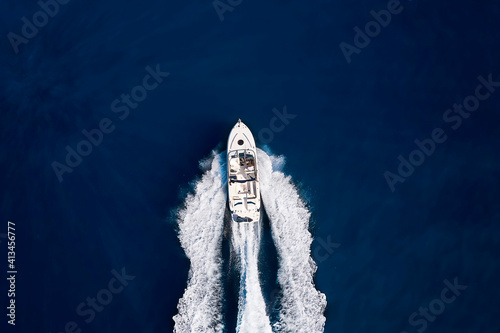 Aerial top down view to a speedboat driving over blue sea with copy space © moofushi
