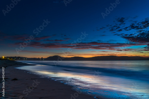 Pretty blue summer sunrise seascape with high cloud