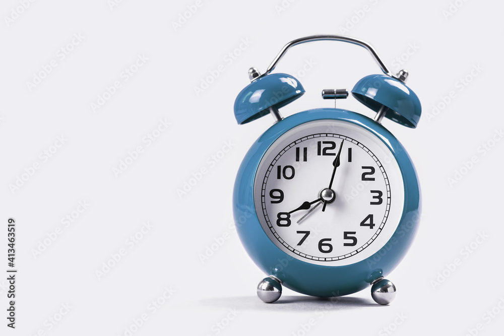 Blue retro alarm clock on white table. Copy space. Blue retro alarm clock on white table. Copy space.