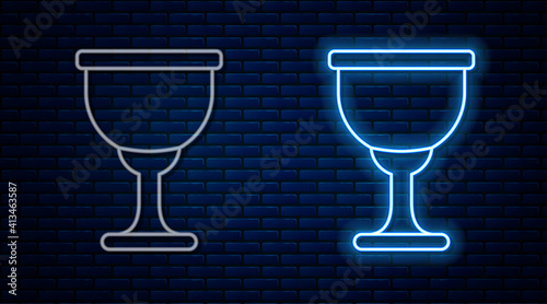 Glowing neon line Holy grail or chalice icon isolated on brick wall background. Christian chalice. Christianity icon. Vector.