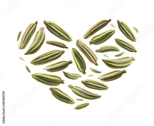 Fennel seeds in the shape of a heart on a white background