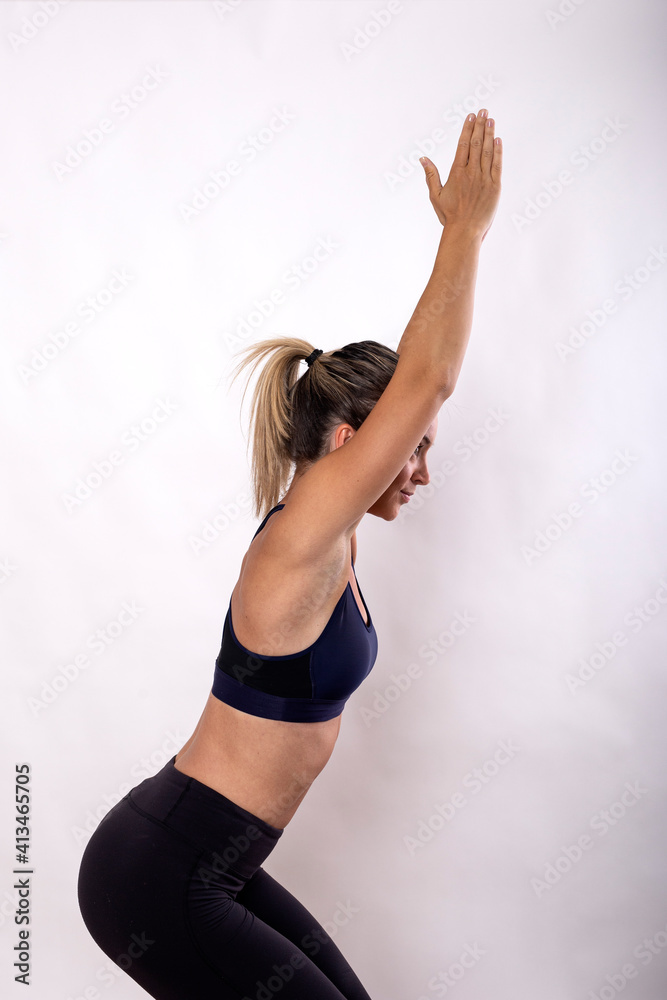 Young beautiful yoga woman in sportswear posing on white background Young beautiful yoga woman in sportswear posing on white background