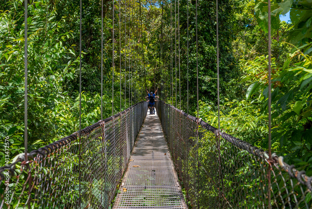 Arenal Hanging Bridges, man hiking in green tropical jungle, Costa Rica, Central America. Arenal Hanging Bridges, man hiking in green tropical jungle, Costa Rica, Central America.