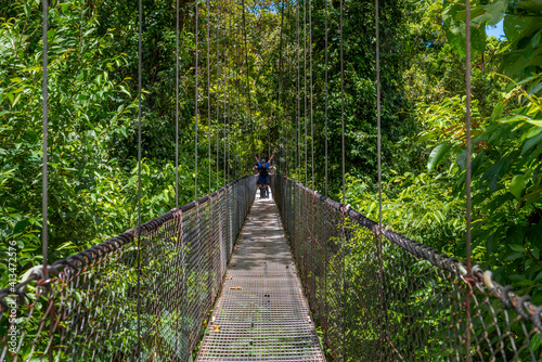 Arenal Hanging Bridges, man hiking in green tropical jungle, Costa Rica, Central America.