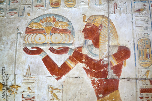 A colourful wall painting with Ancient Egyptian Pharaoh presenting offerings to the gods, Abydos, Egypt photo