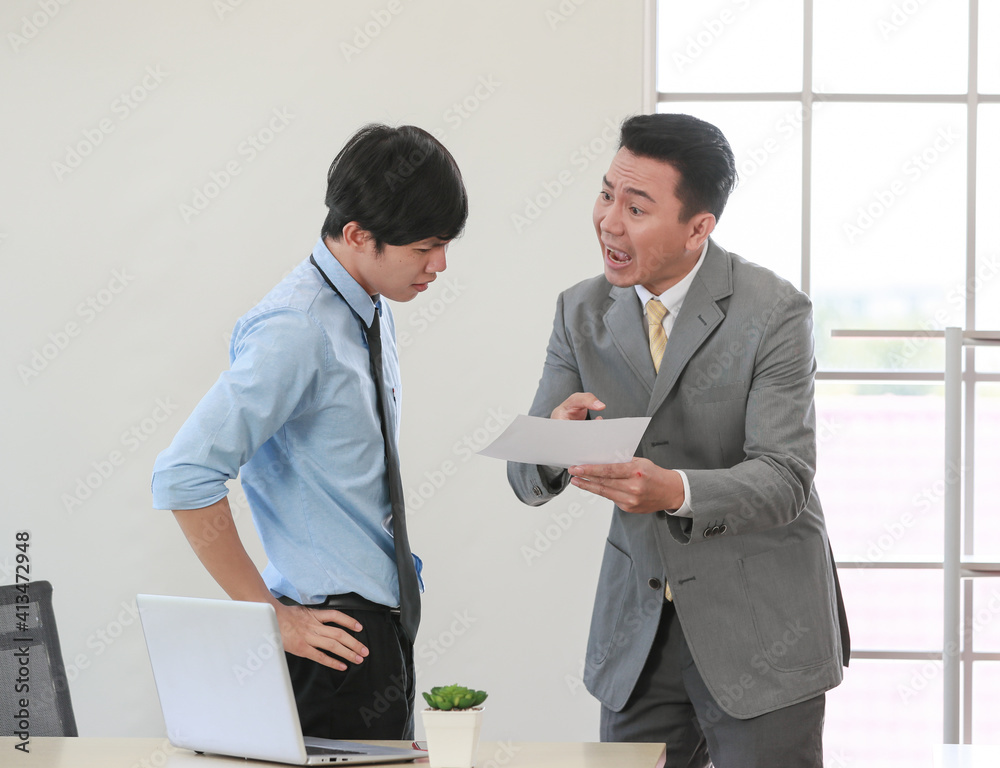 .Senior Asain businessman boss feel unhappy with serious face and argue with young junior employee. Daily problem from working in office concept .Senior Asain businessman boss feel unhappy with serious face and argue with young junior employee. Daily problem from working in office concept