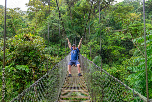 Arenal Hanging Bridges, man hiking in green tropical jungle, Costa Rica, Central America.