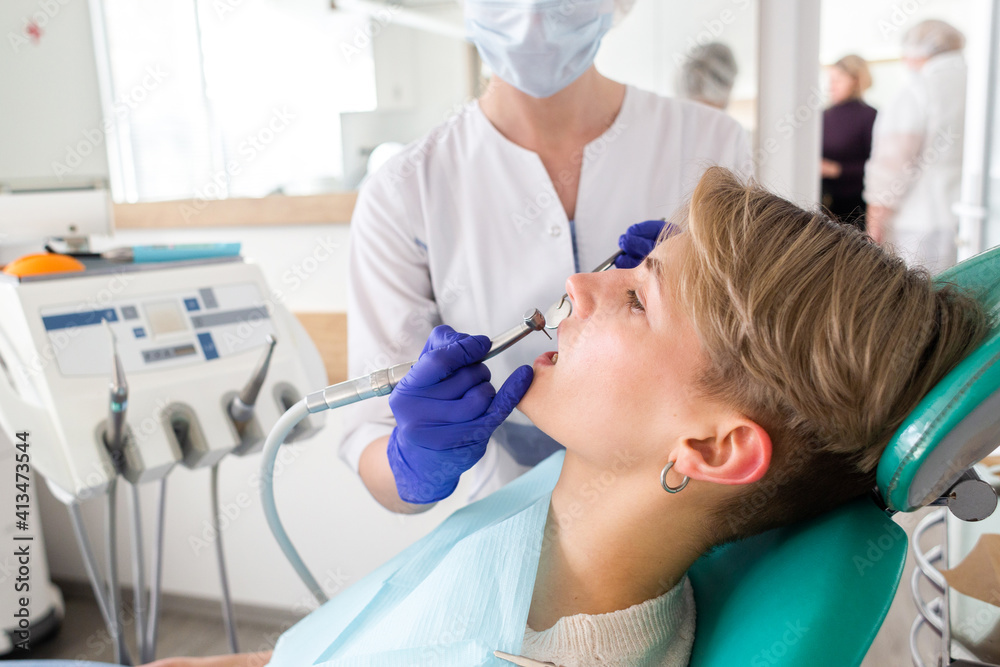 Woman at the dentist consultation. Checking and dental treatment in a clinic Woman at the dentist consultation. Checking and dental treatment in a clinic