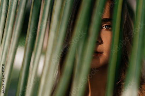 portrait of tender woman looking out of palm leaf Bali Indonesia