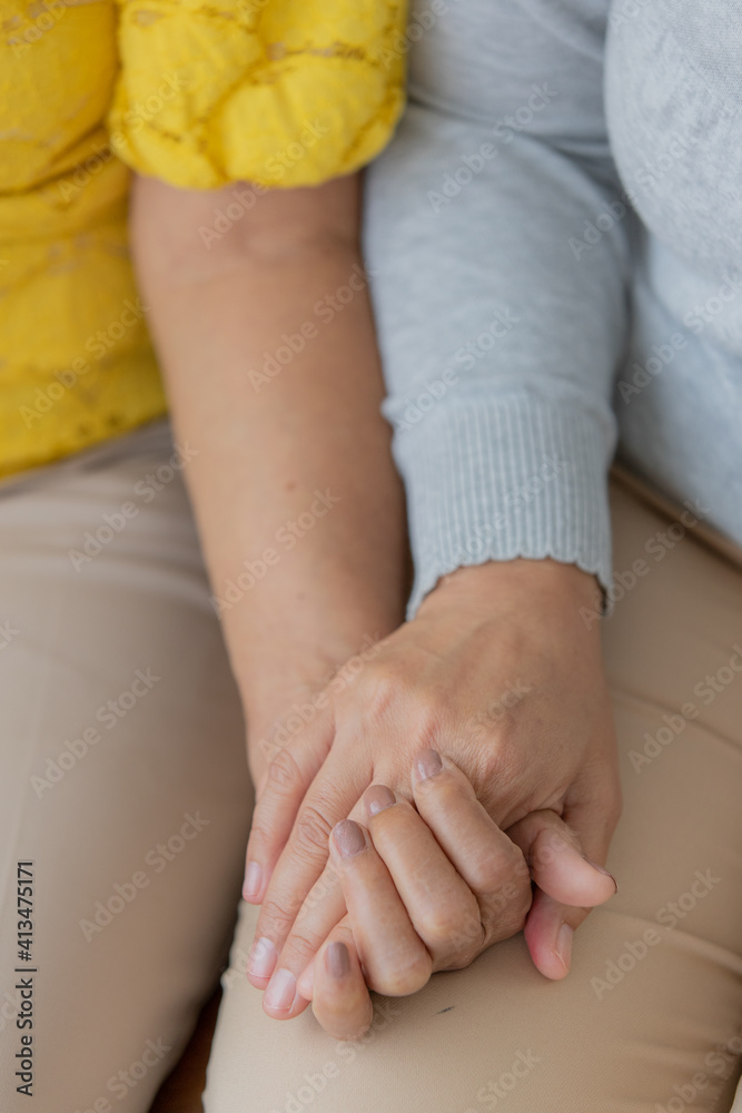 Hands of Young and old woman catching together with love and trust Hands of Young and old woman catching together with love and trust