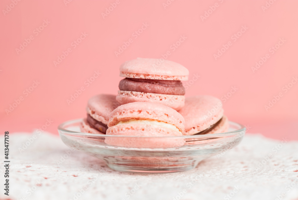 Pink homemade macarons on a pink background