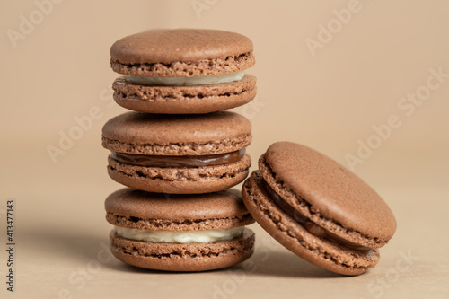 Brown homemade macarons, on a brown background