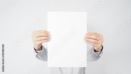 Man hold blank empty paper and wear shirt on white background.asian people