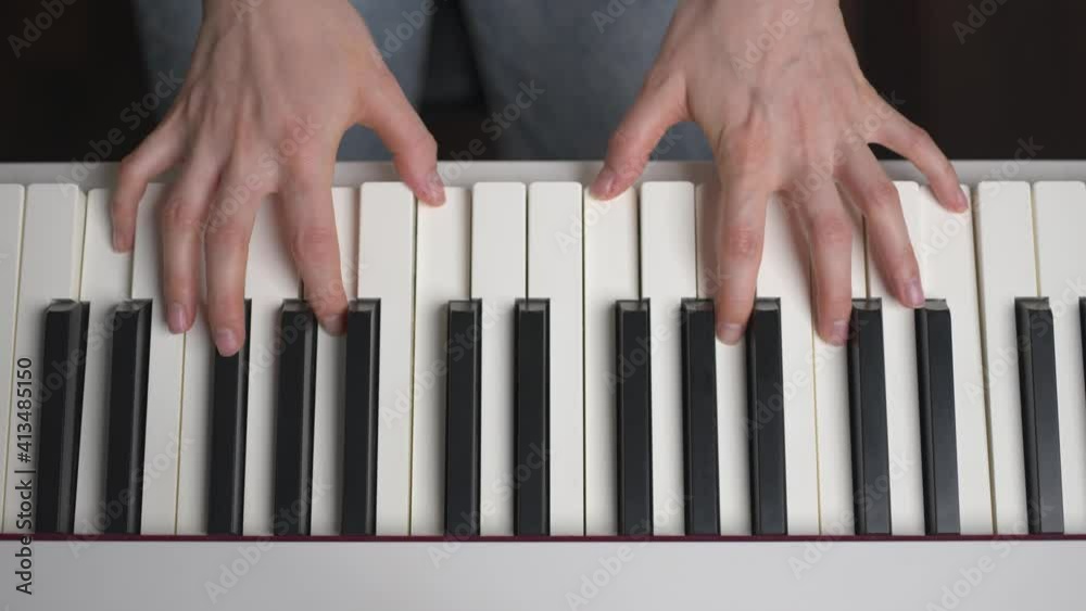 Overhead view of caucasian woman hands playing piano