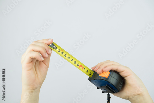 Female hands hold a tape measure to measure the size. Isolated on white background