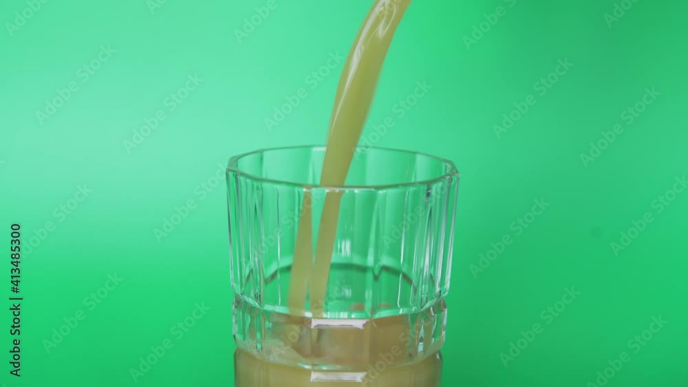 Greenscreen Closeup: Filling a Glass with Orange juice Greenscreen Closeup: Filling a Glass with Orange juice