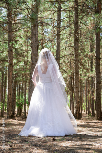 Happy bride in a wedding dress, against the backdrop of beautiful nature. Wedding day