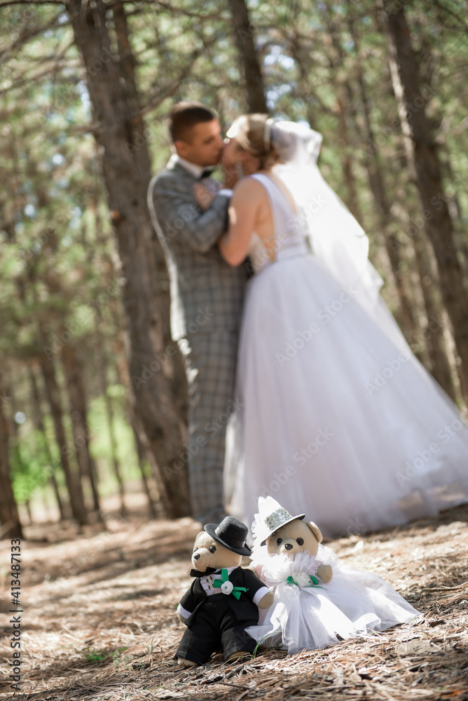 Blurred image of kissing bride and groom.