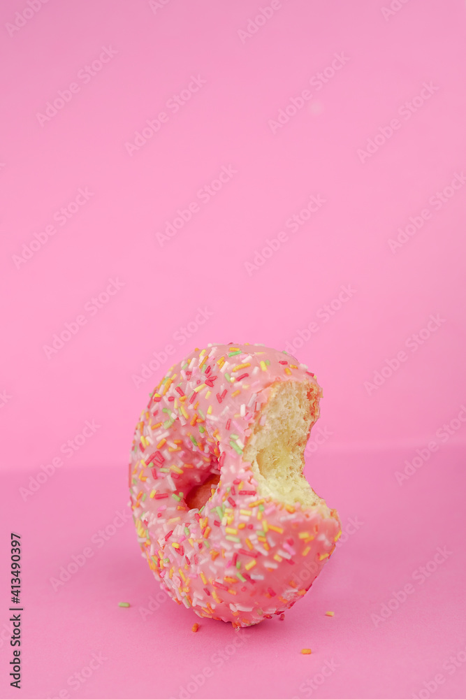 Pink donut on yellow background. Icing sugar sweet food. Colorful snack dessert. Glazed sprinkles. Enjoy a delicious pastry breakfast. Bakery cake. Donut with glaze Pink donut on yellow background. Icing sugar sweet food. Colorful snack dessert. Glazed sprinkles. Enjoy a delicious pastry breakfast. Bakery cake. Donut with glaze