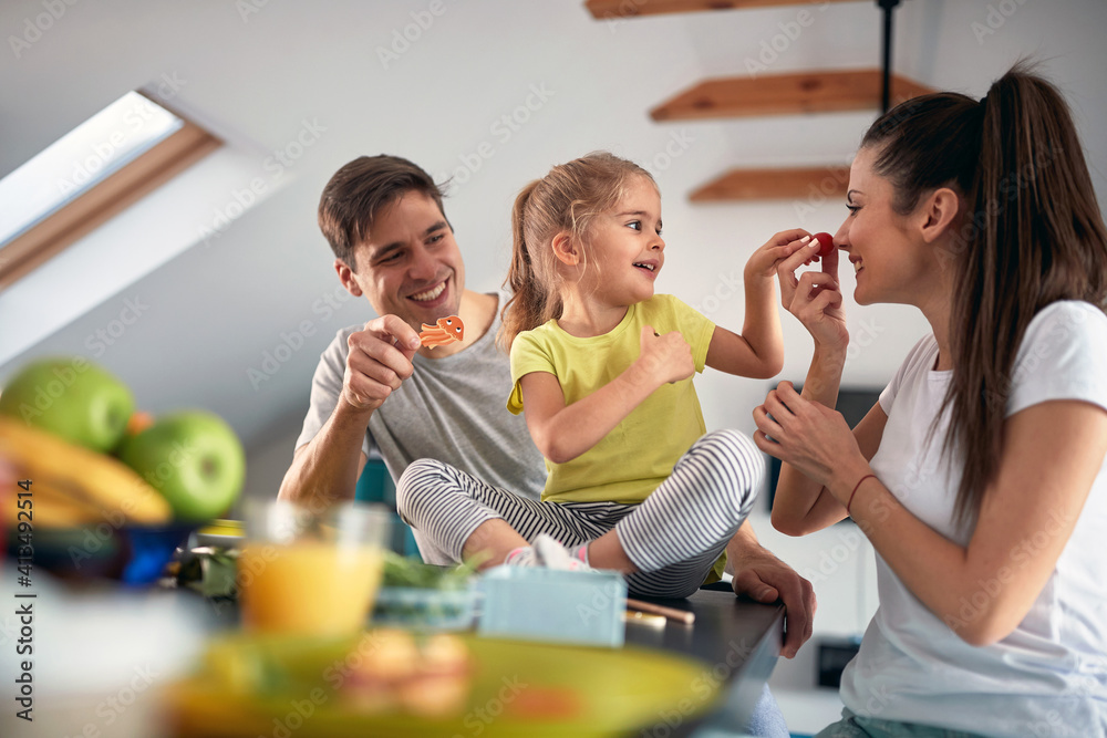 Caucasian couple wiith daughter having breakfast together - obrazy, fototapety, plakaty 