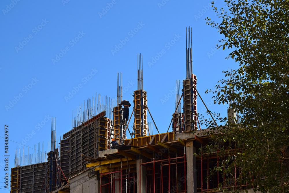 Technology to build modern high-rise house. Monolithic frame building. Construction site with workers. Technology to build modern high-rise house. Monolithic frame building. Construction site with workers.