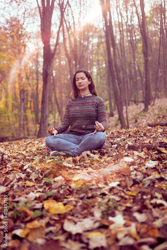 Woman meditationg in forest, Connected with Nature, Breathing ,Peace and Freedom concept photo