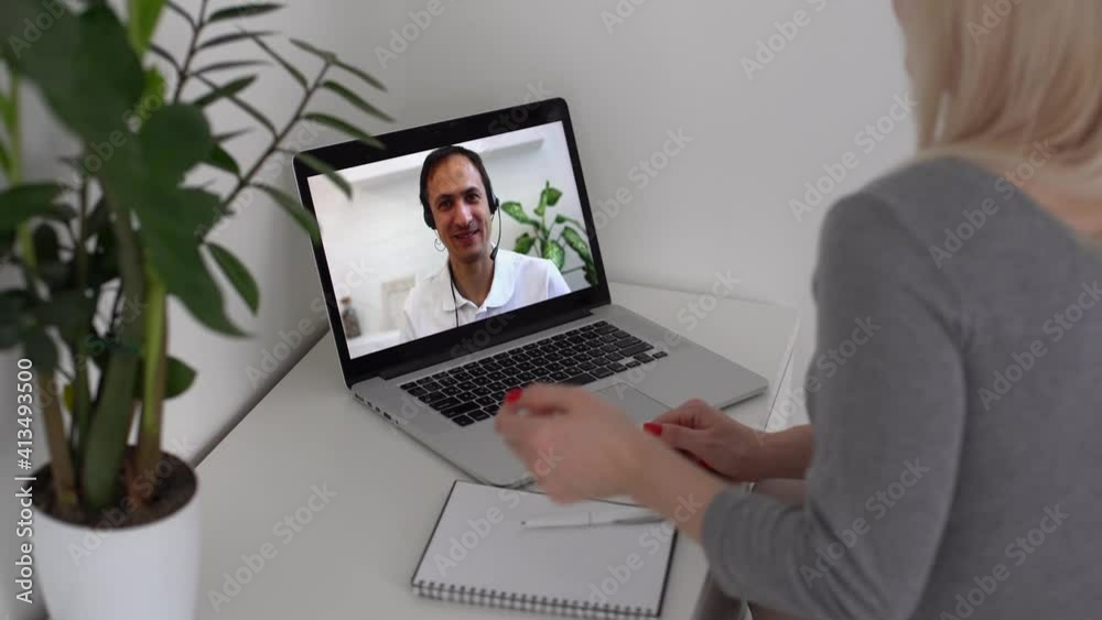 Back view of business woman talking to her colleagues about plan in video conference. business team using laptop for a online meeting in video call. Group of people smart working from home. Back view of business woman talking to her colleagues about plan in video conference. business team using laptop for a online meeting in video call. Group of people smart working from home.
