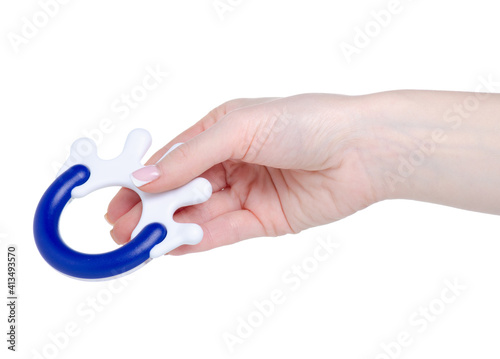 Baby rattle toy in hand on white background isolation