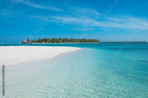 turquoise water and white sand beach on the island of dhiffushi, maldives. 