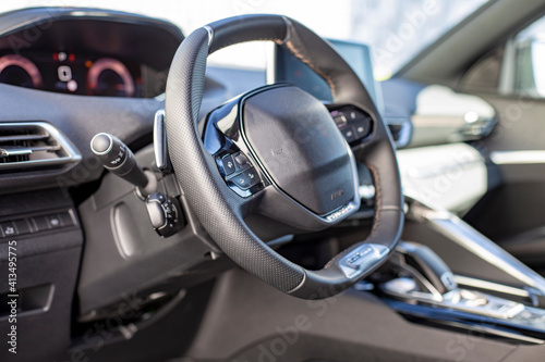 empty interior of driver's seat and steering wheel of a modern fashionable car © Maria