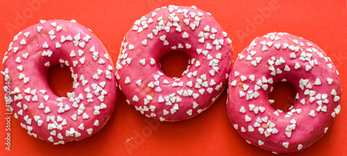Baked donuts on red background