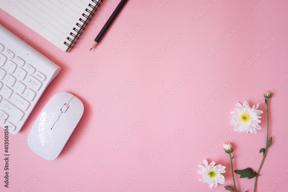 Cropped shot view of pink office desk table with the office equipments, and other office supplies on the modern space, flat lay. Cropped shot view of pink office desk table with the office equipments, and other office supplies on the modern space, flat lay.