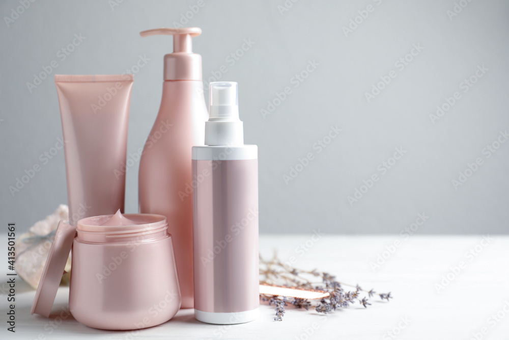 Set of hair care cosmetic products on white table. Space for text Set of hair care cosmetic products on white table. Space for text