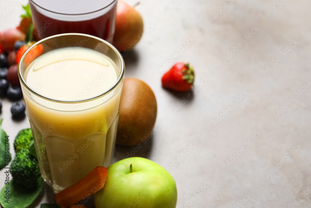 Delicious juice and fresh ingredients on grey table. Space for text Delicious juice and fresh ingredients on grey table. Space for text