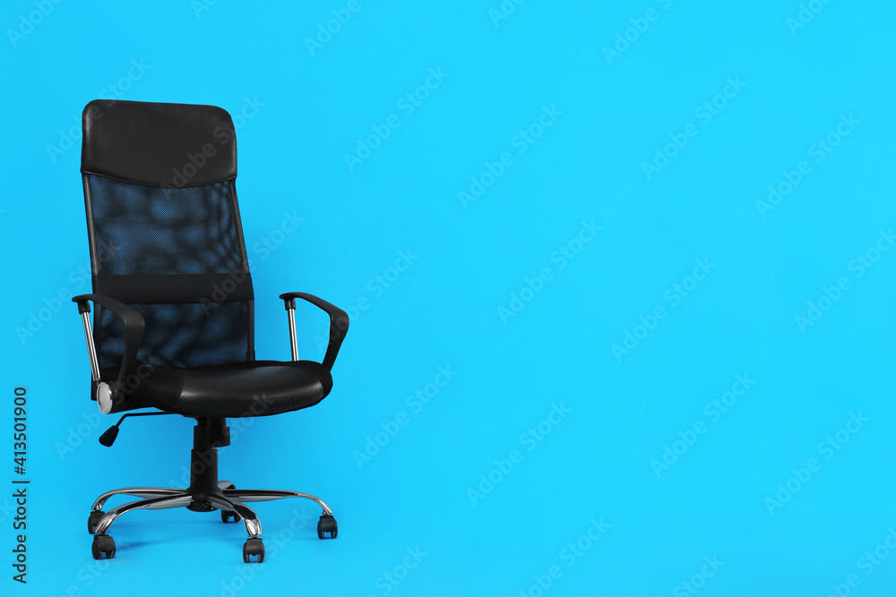 Comfortable office chair on light blue background, space for text Comfortable office chair on light blue background, space for text