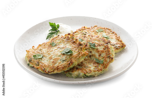 Delicious zucchini fritters with sour cream and parsley isolated on white