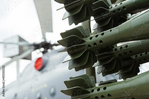 Quadro em tela A fragment of a mortar shell against the background of a military helicopter