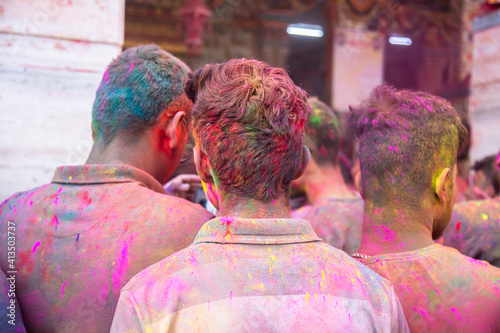 Jodhpur, rajastha, india - March 20, 2020: indian people singing and dancing while celebrating holi festival, face covered with colored powder. photo