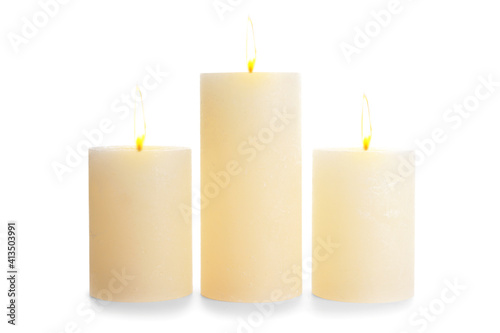 Glowing candles on white background