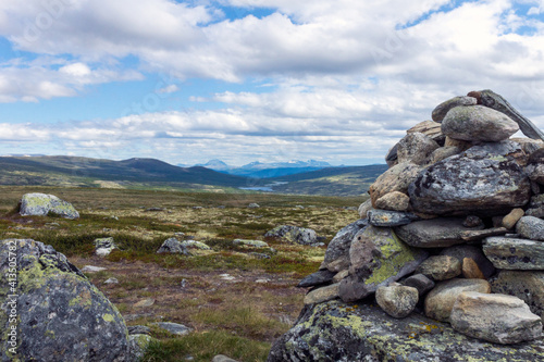 Stone cairn towards beautiful landscape scenery. © Jon Anders Wiken
