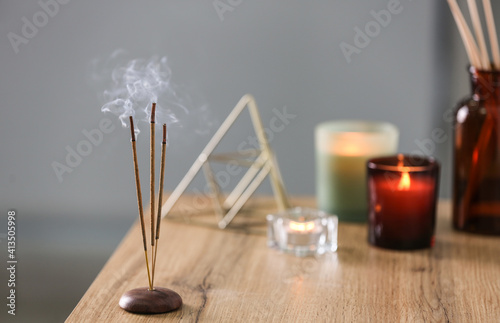 Canvas Print Incense sticks smoldering on table indoors, space for text