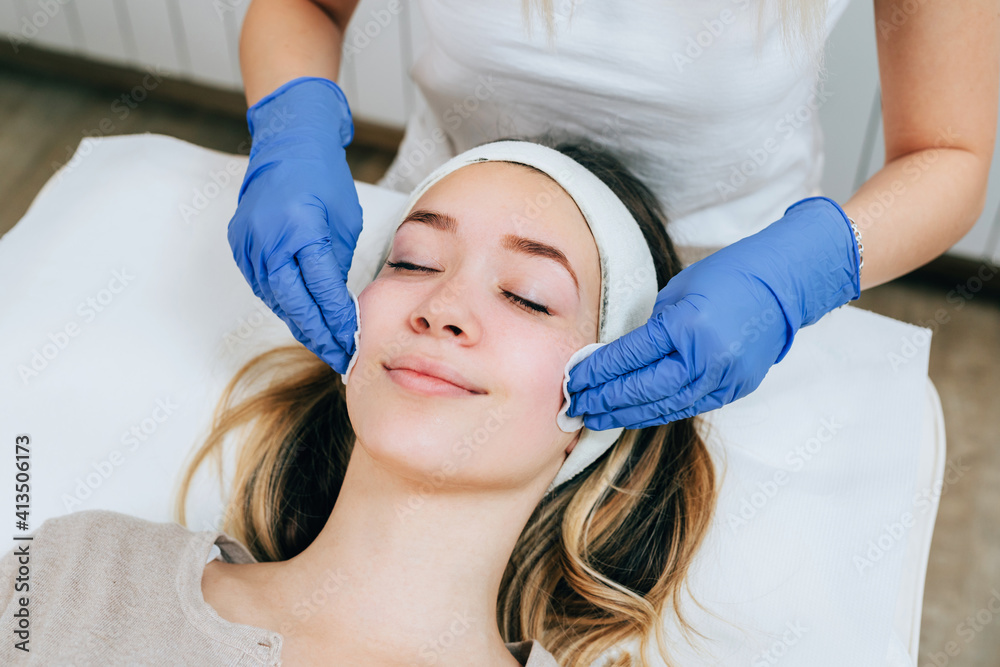 Young woman enjoying skin rejuvenation therapy at cosmetology center.