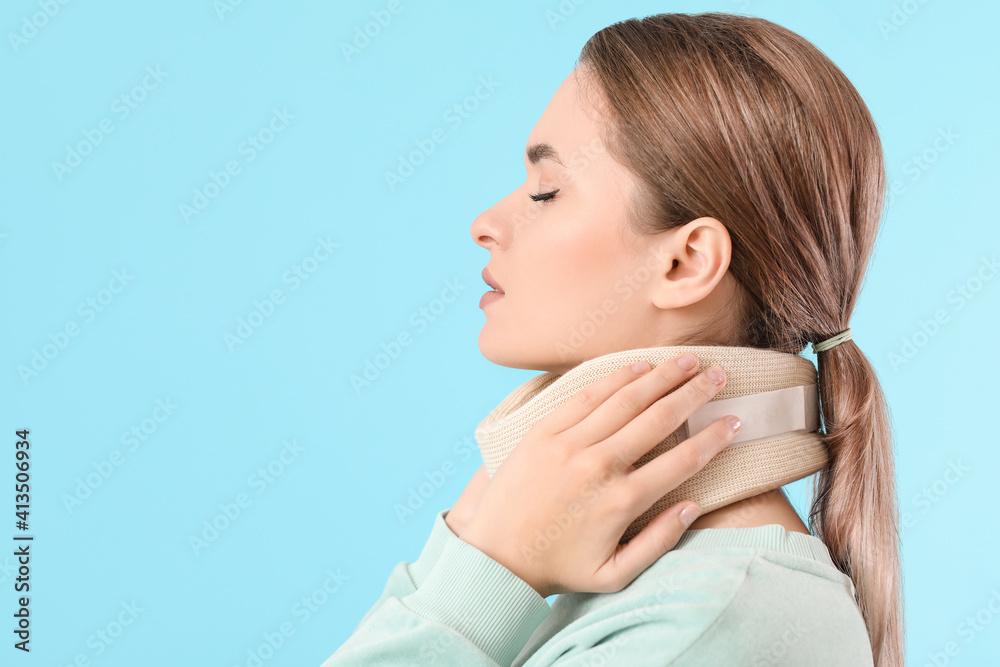 Young woman with cervical collar on neck against color background Young woman with cervical collar on neck against color background
