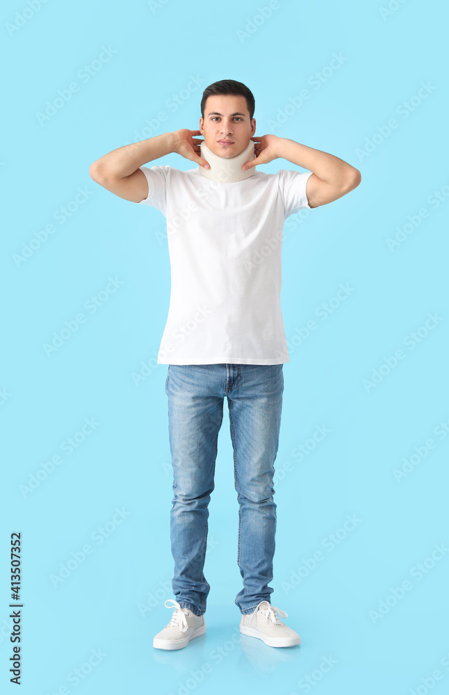 Young man with cervical collar on neck against color background Young man with cervical collar on neck against color background